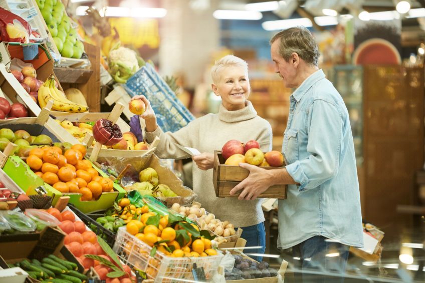 Senior couple grocery shopping during National Nutrition Month.