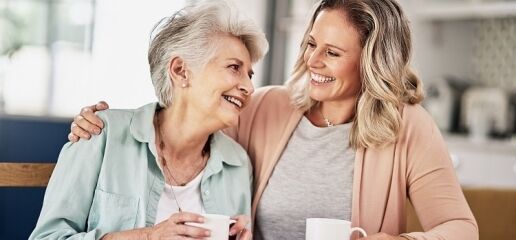 Happy resident and caregiver in a memory care community